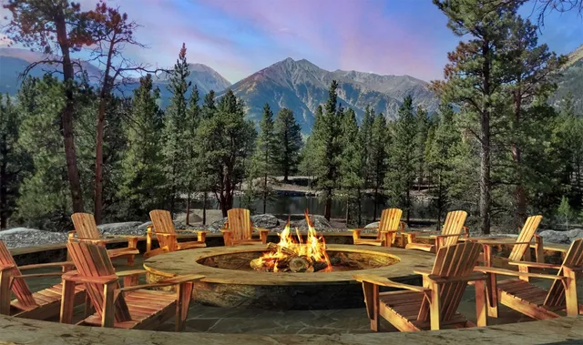 a view of a patio with table and chairs and couches with wooden floor and fence