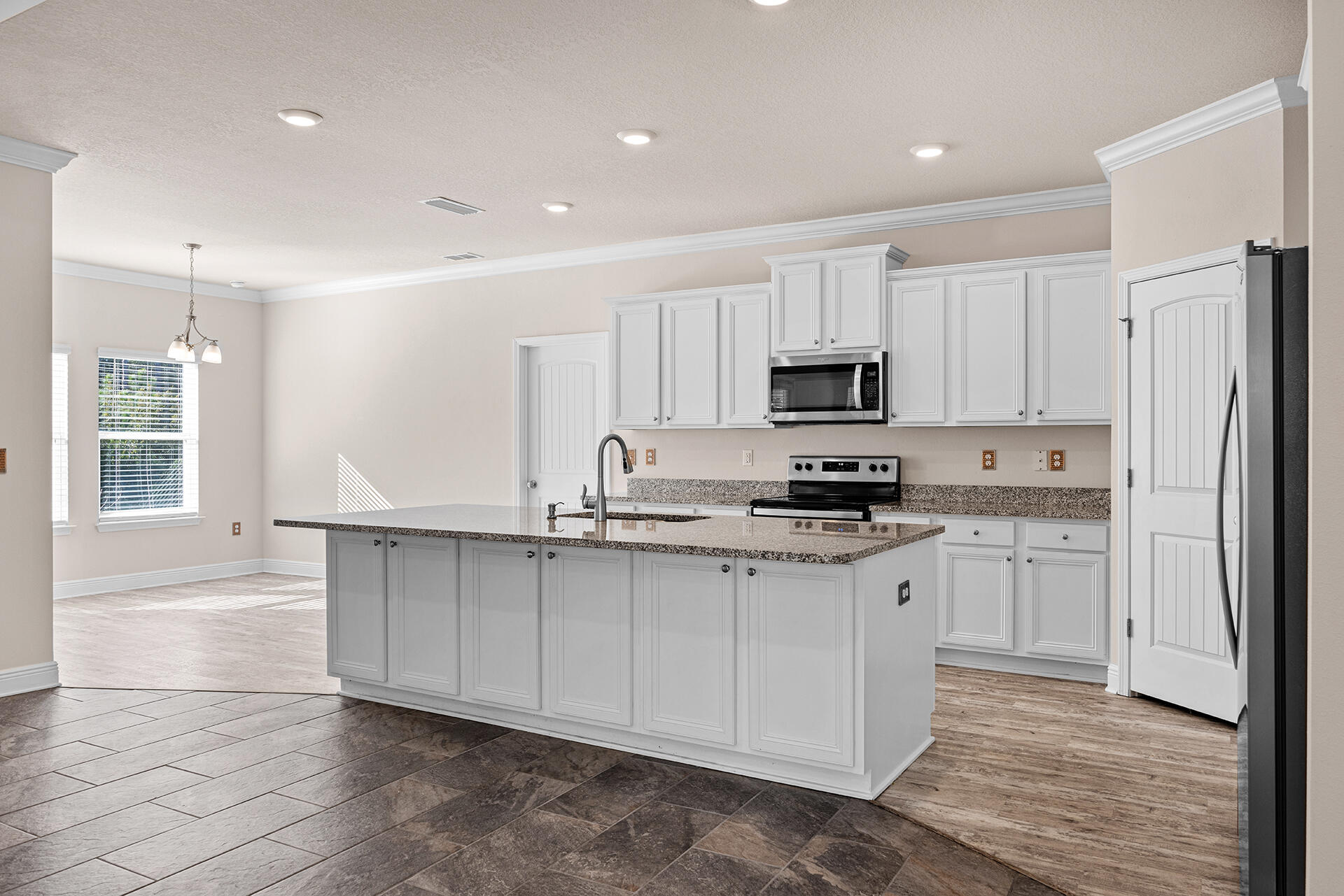 220 Conner Circle Santa Rosa Beach, FL 32459 - Photo 29 of 50 a kitchen with granite countertop white cabinets and stainless steel appliances