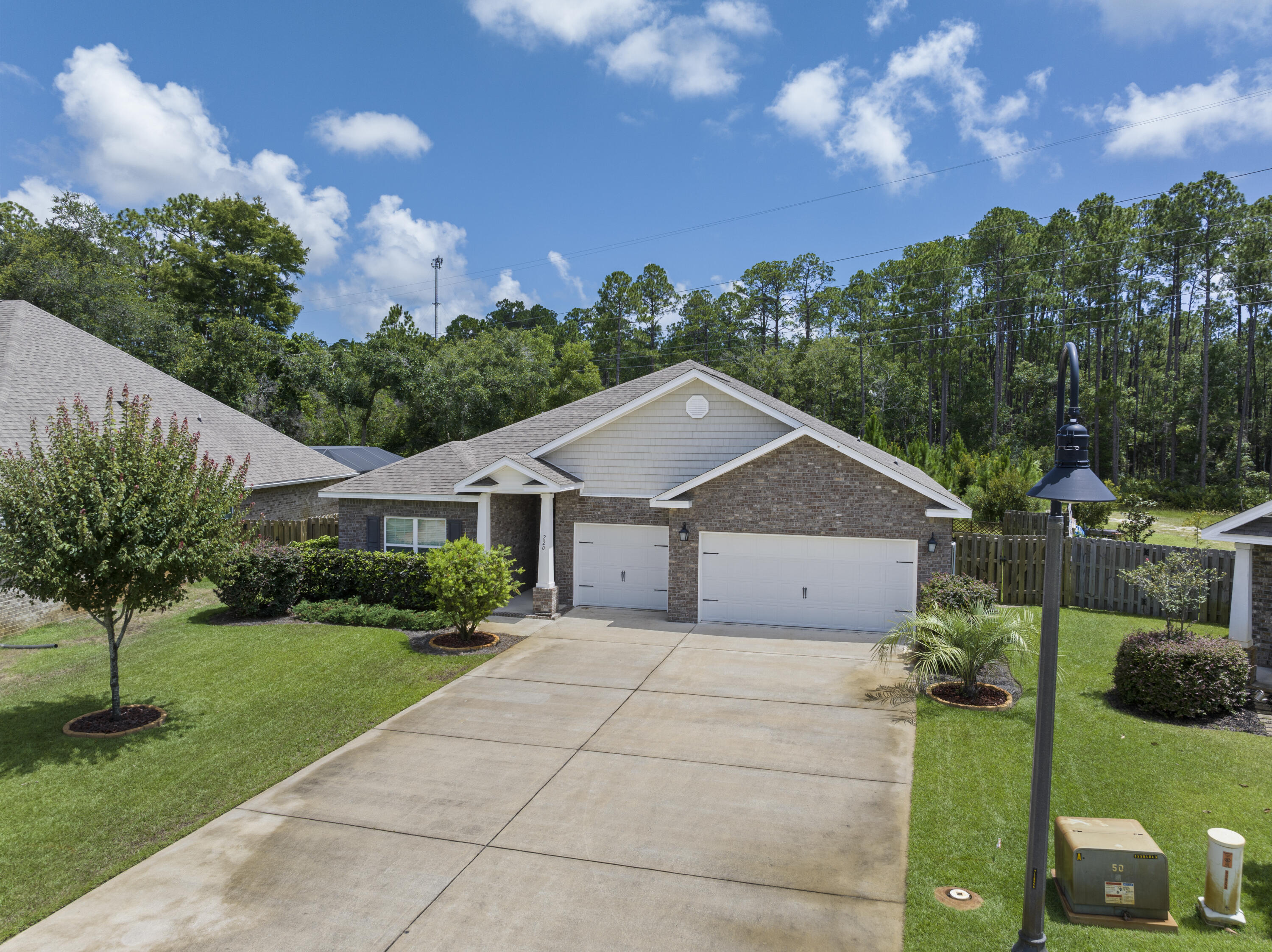220 Conner Circle Santa Rosa Beach, FL 32459 - Photo 3 of 50 a view of a house with a big yard plants and large trees
