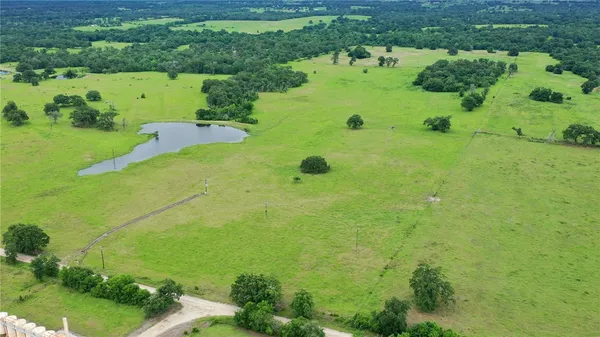 an aerial view of huge green field with lots of green space