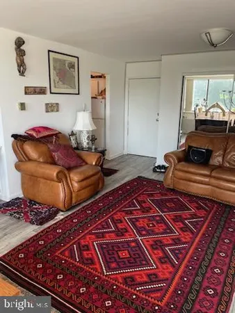 a bedroom with two beds and painting on the wall