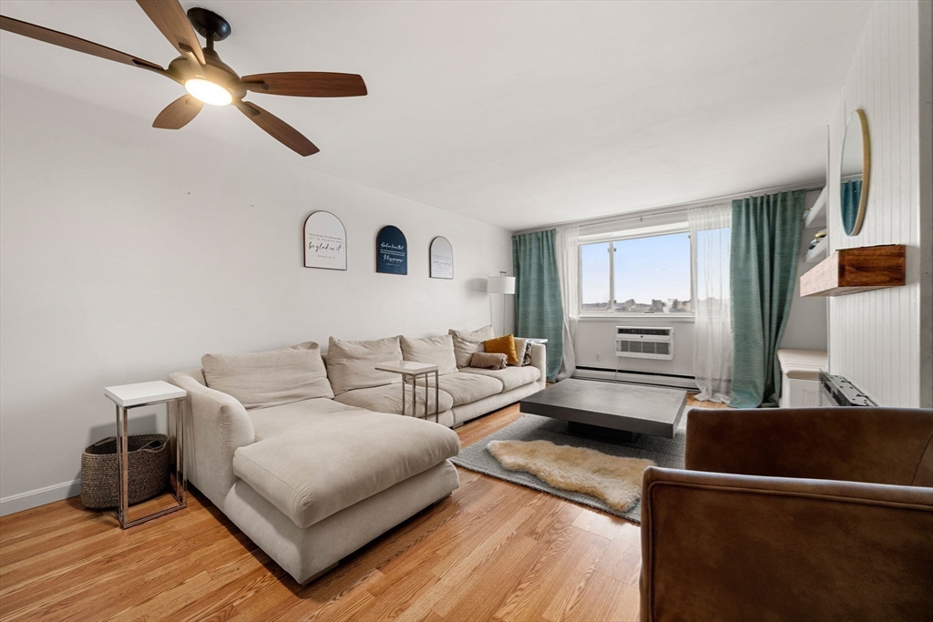 94 Beacon Street, Unit 83 Somerville, MA 02143 - Photo 5 of 22 a living room with furniture and a wooden floor