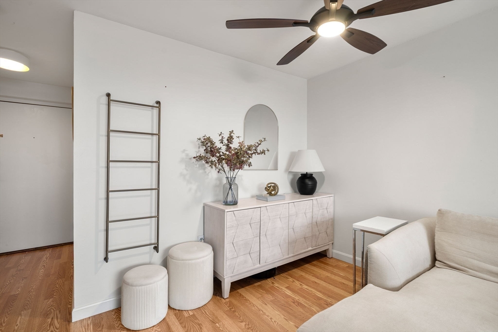 94 Beacon Street, Unit 83 Somerville, MA 02143 - Photo 6 of 22 a living room with furniture and wooden floor