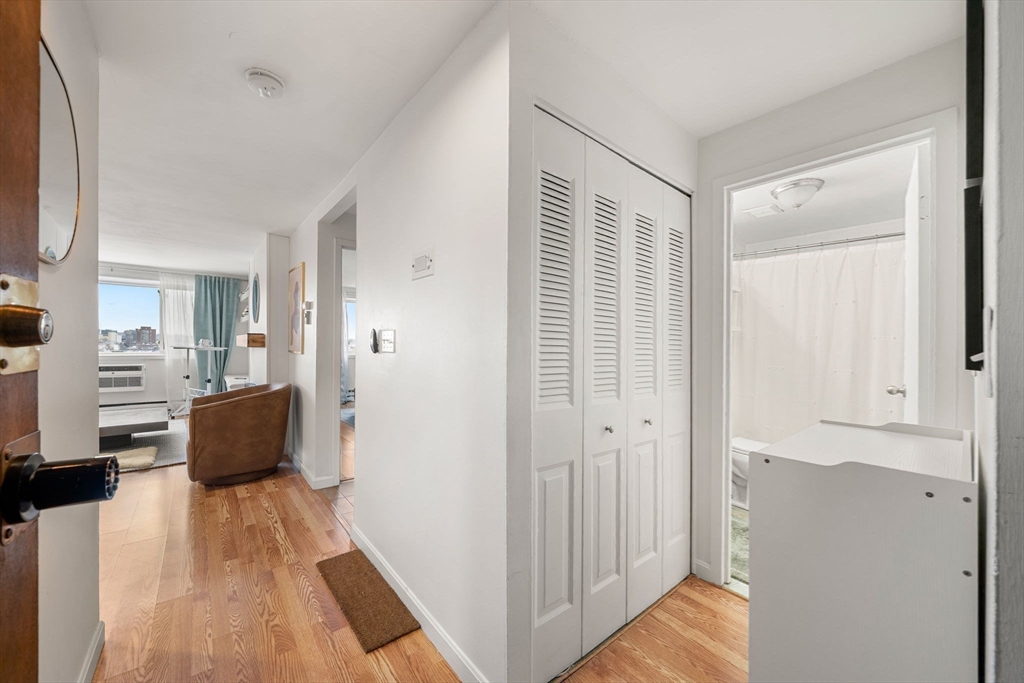94 Beacon Street, Unit 83 Somerville, MA 02143 - Photo 7 of 22 a view of a bedroom with furniture and wooden floor