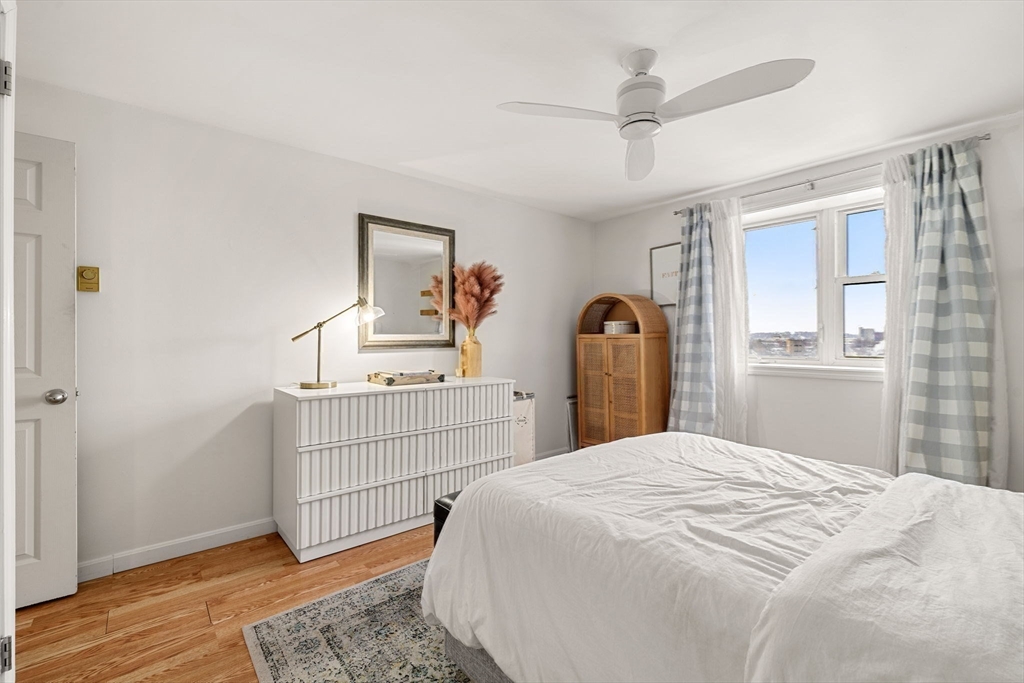 94 Beacon Street, Unit 83 Somerville, MA 02143 - Photo 8 of 22 a bedroom with a bed and a dresser