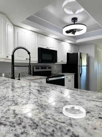 a living room with a bed furniture and a large window