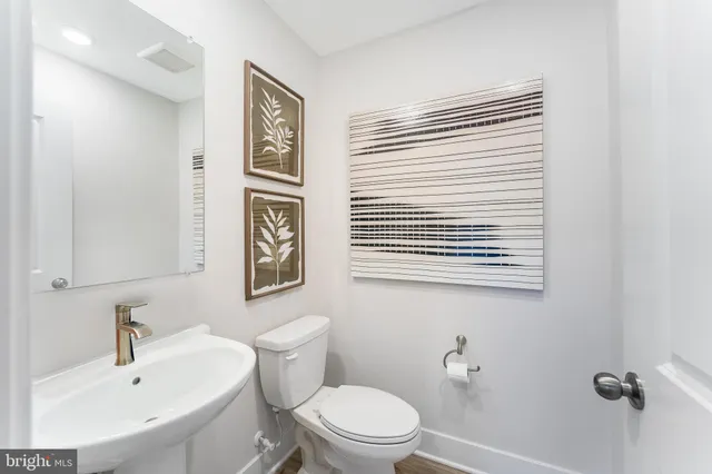 a bathroom with a sink a mirror and a toilet