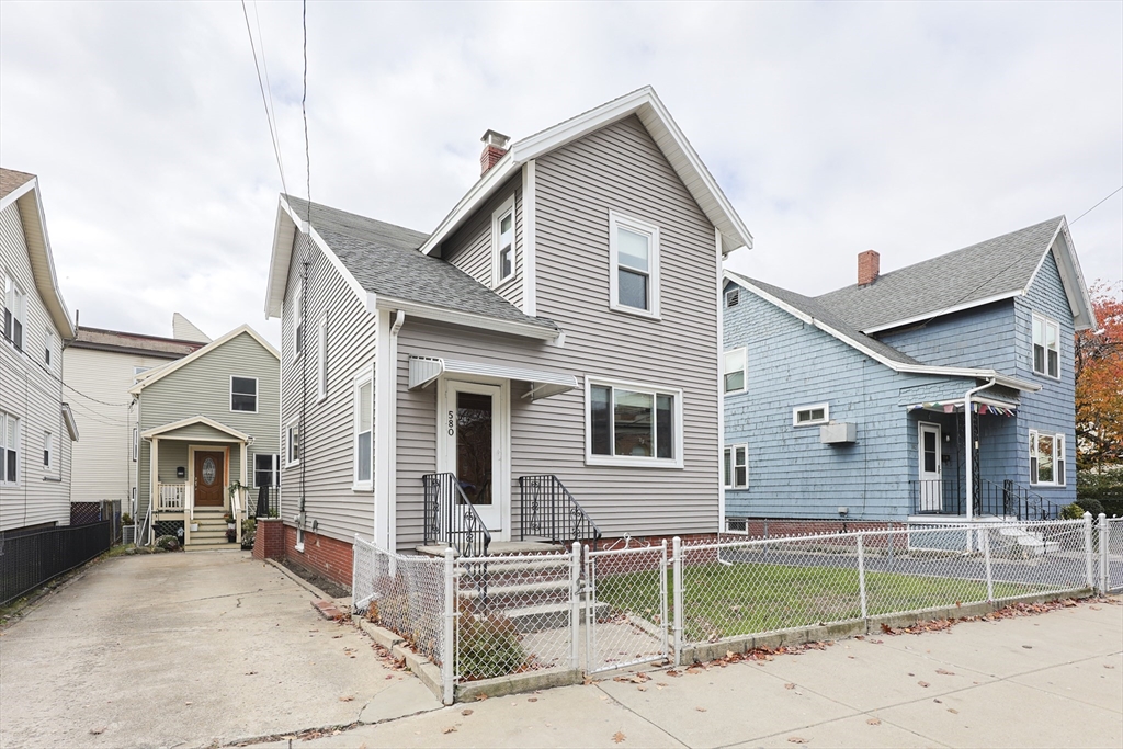 580 2nd Street Everett, MA 02149 - Photo 1 of 29 a view of a white house with a large windows and couches chairs