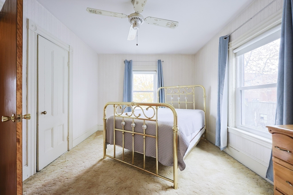 580 2nd Street Everett, MA 02149 - Photo 18 of 29 a bedroom with a bed and a window