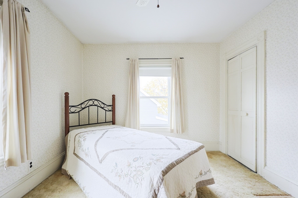 580 2nd Street Everett, MA 02149 - Photo 19 of 29 a bedroom with a bed and a window