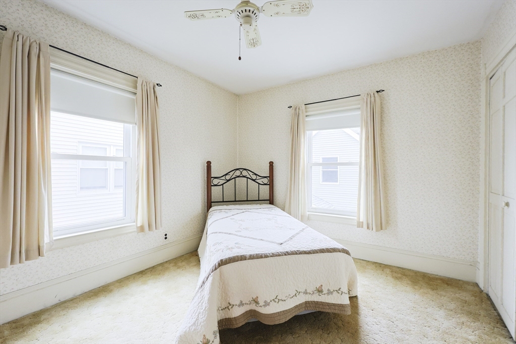 580 2nd Street Everett, MA 02149 - Photo 20 of 29 a bedroom with a bed and a window