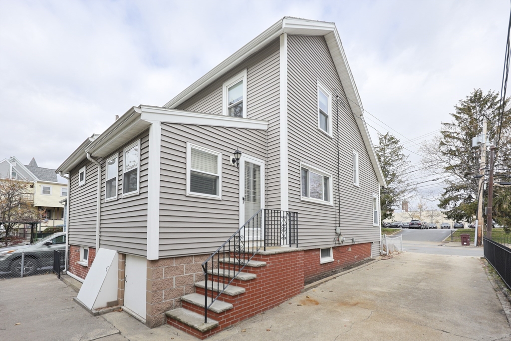 580 2nd Street Everett, MA 02149 - Photo 2 of 29 a front view of a house with a garage