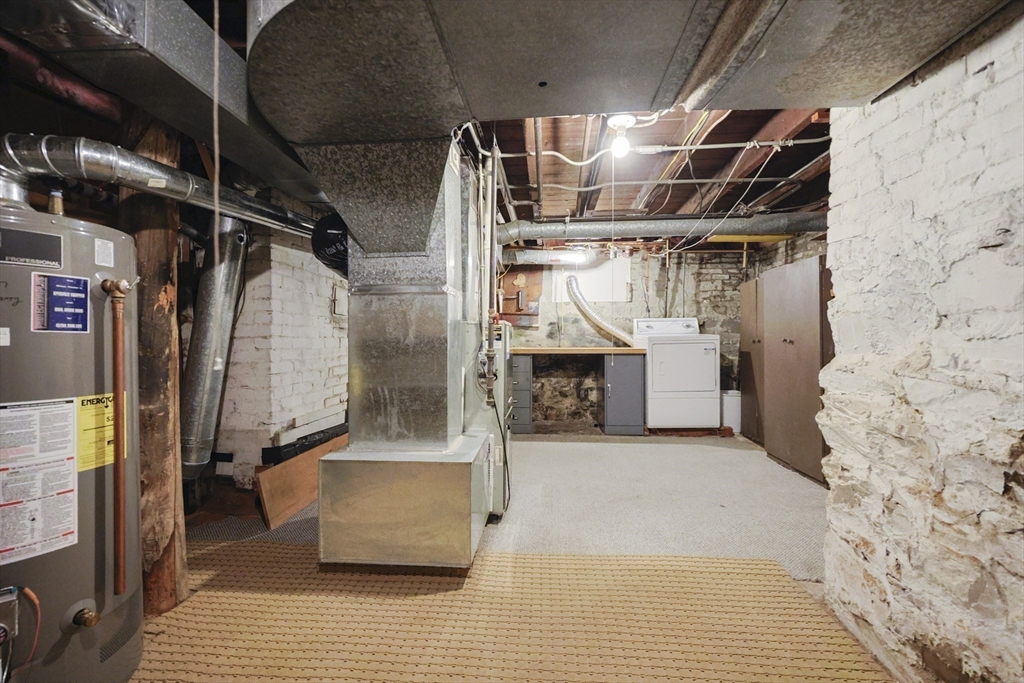 580 2nd Street Everett, MA 02149 - Photo 27 of 29 a view of water heater room with wooden floor