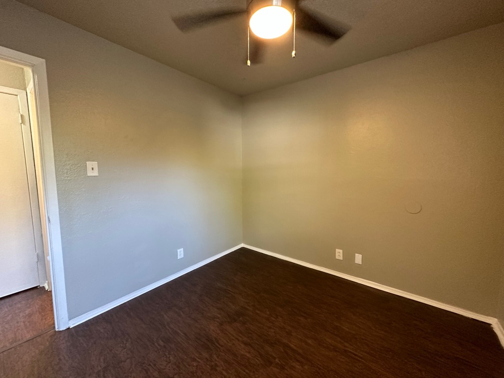 903 Taulbee Lane, Unit B Austin, TX 78757 - Photo 16 of 20 an empty room with wooden floor and windows