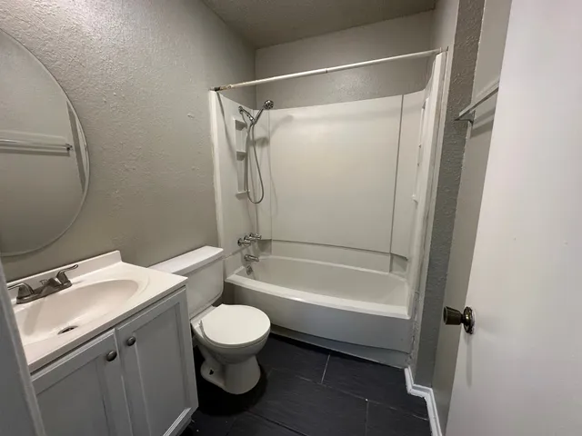 a bathroom with a toilet a sink and a mirror