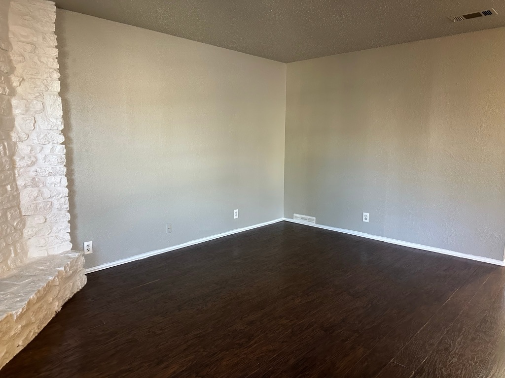 903 Taulbee Lane, Unit B Austin, TX 78757 - Photo 3 of 20 a view of an empty room with wooden floor and a window