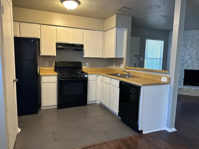 a kitchen with a refrigerator and a stove