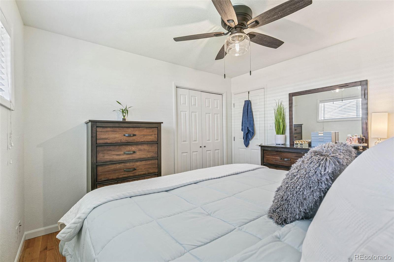 10800 Larry Drive Northglenn, CO 80233 - Photo 11 of 28 a bedroom with a bed and a chandelier