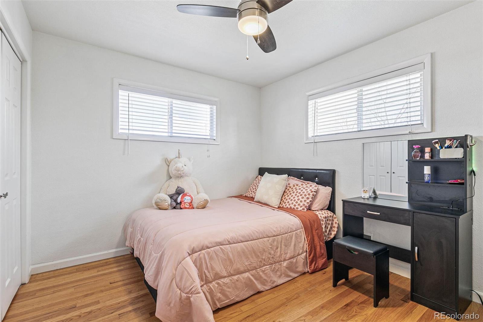 10800 Larry Drive Northglenn, CO 80233 - Photo 14 of 28 a bedroom with a bed dresser and a window