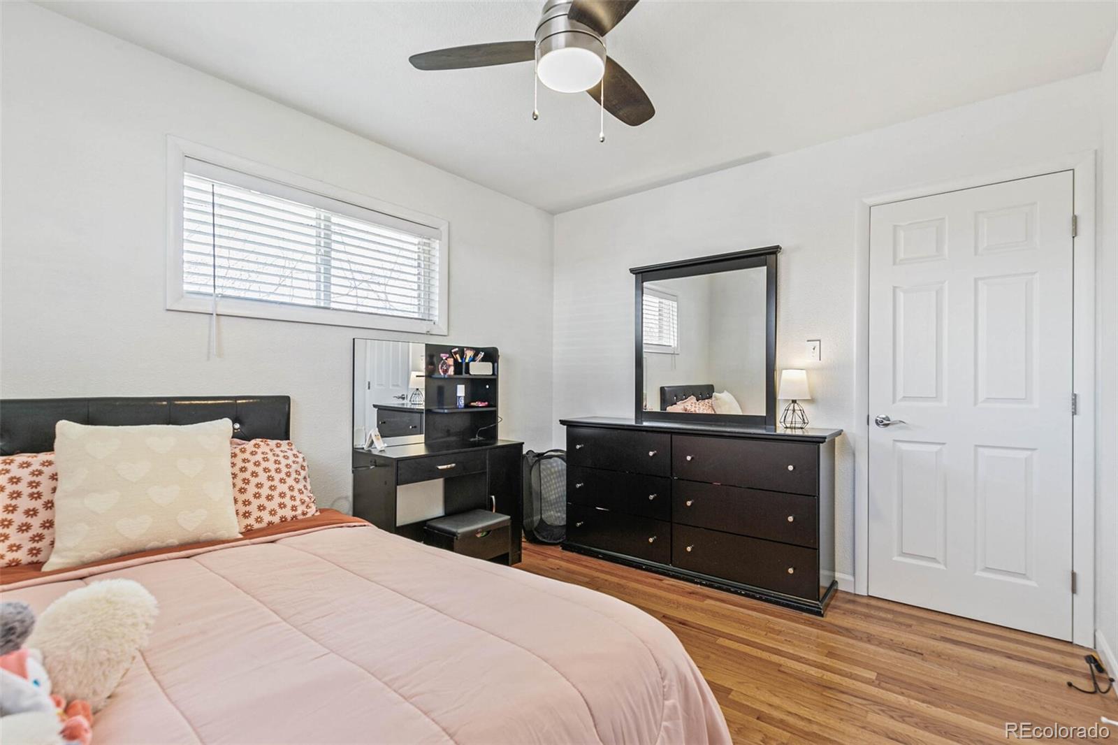 10800 Larry Drive Northglenn, CO 80233 - Photo 15 of 28 a bedroom with a bed and a dresser