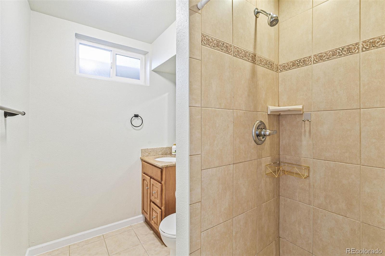 10800 Larry Drive Northglenn, CO 80233 - Photo 20 of 28 a bathroom with a shower