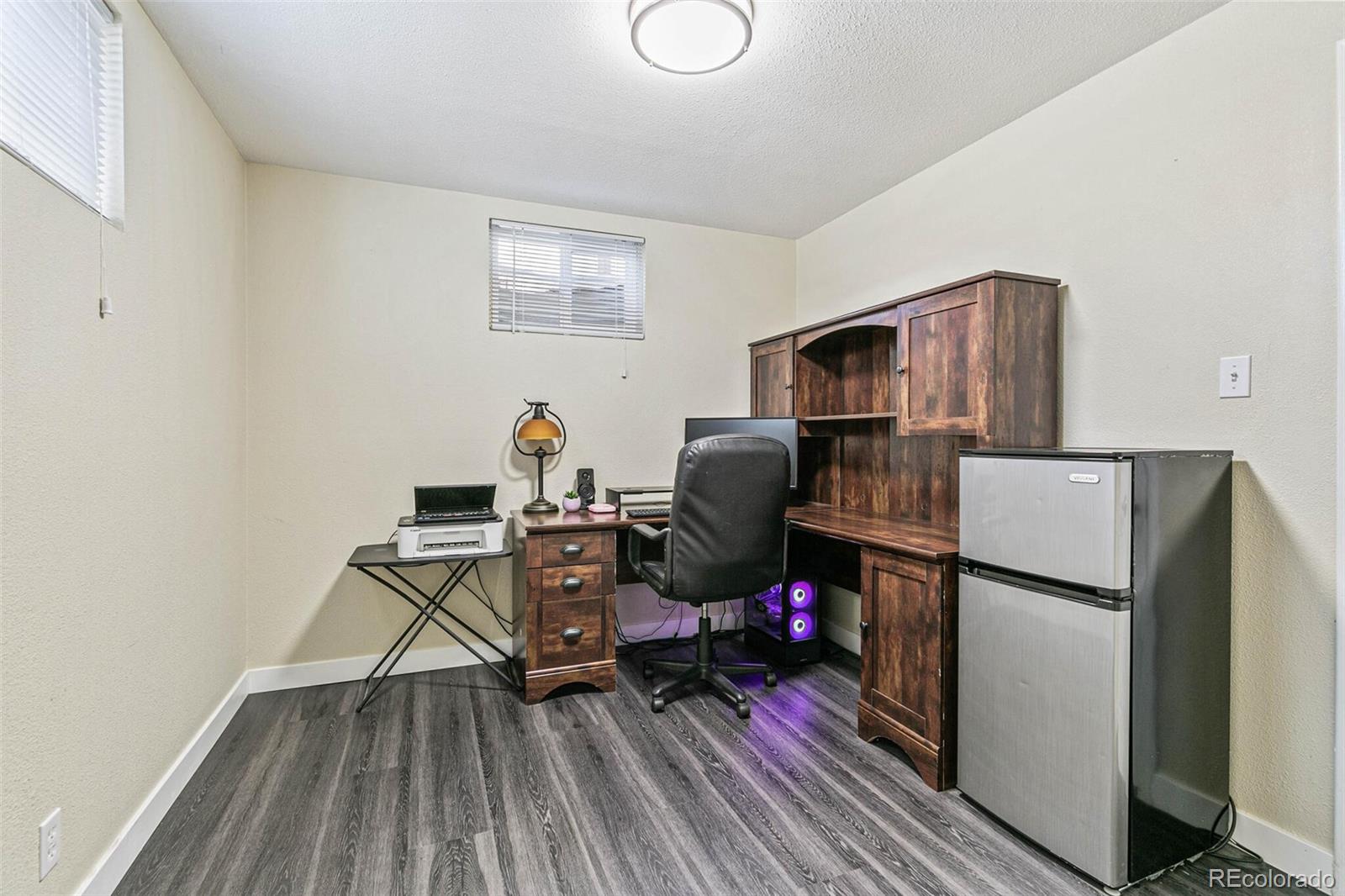 10800 Larry Drive Northglenn, CO 80233 - Photo 22 of 28 a storage room with wooden floor and cabinets