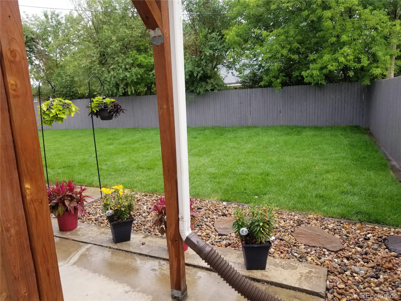 10800 Larry Drive Northglenn, CO 80233 - Photo 26 of 28 a view of a backyard with garden and plants