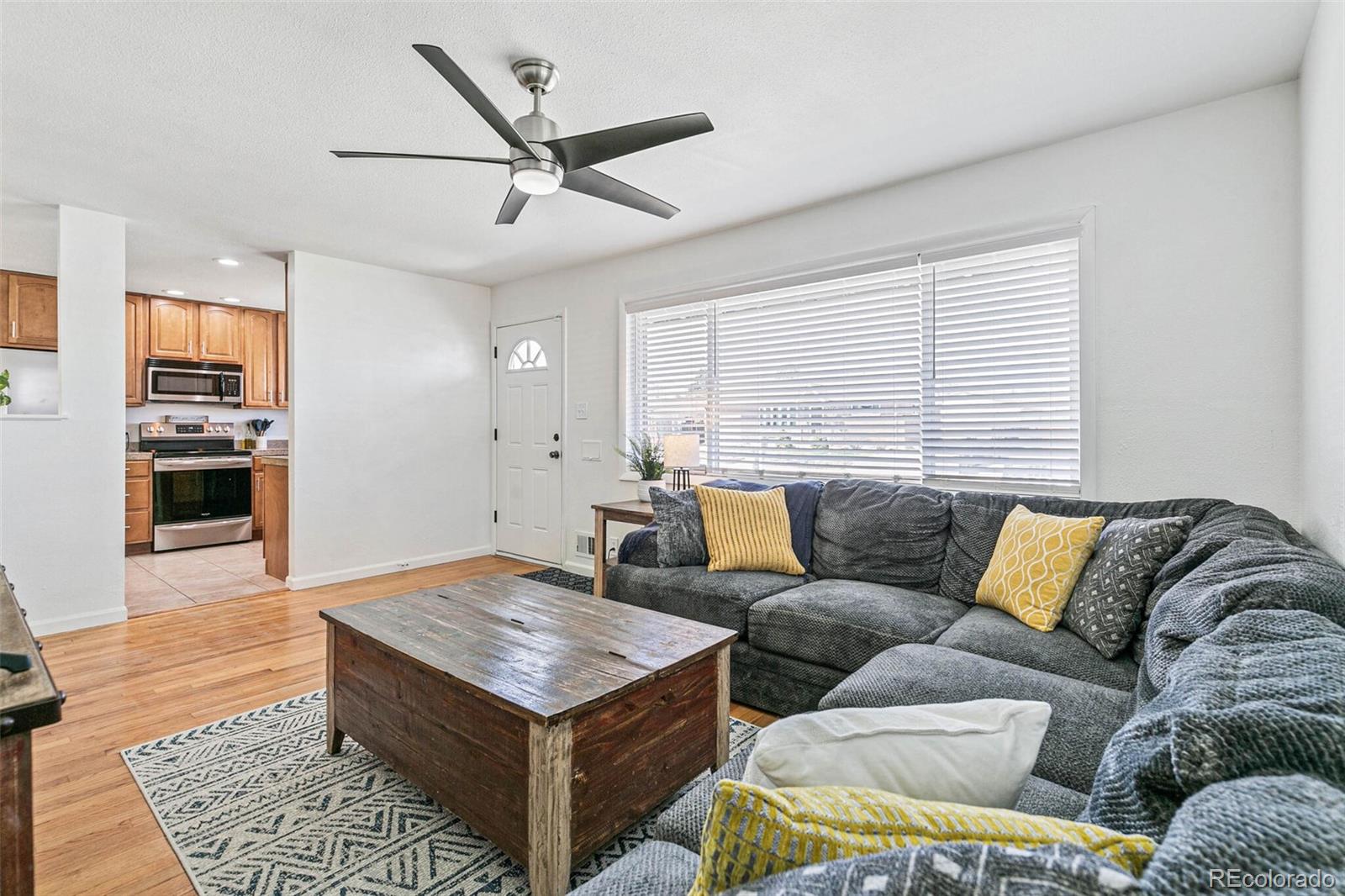 10800 Larry Drive Northglenn, CO 80233 - Photo 5 of 28 a living room with furniture and wooden floor