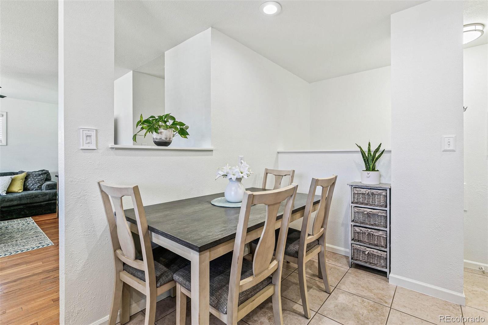 10800 Larry Drive Northglenn, CO 80233 - Photo 9 of 28 a view of a dining room with furniture and wooden floor