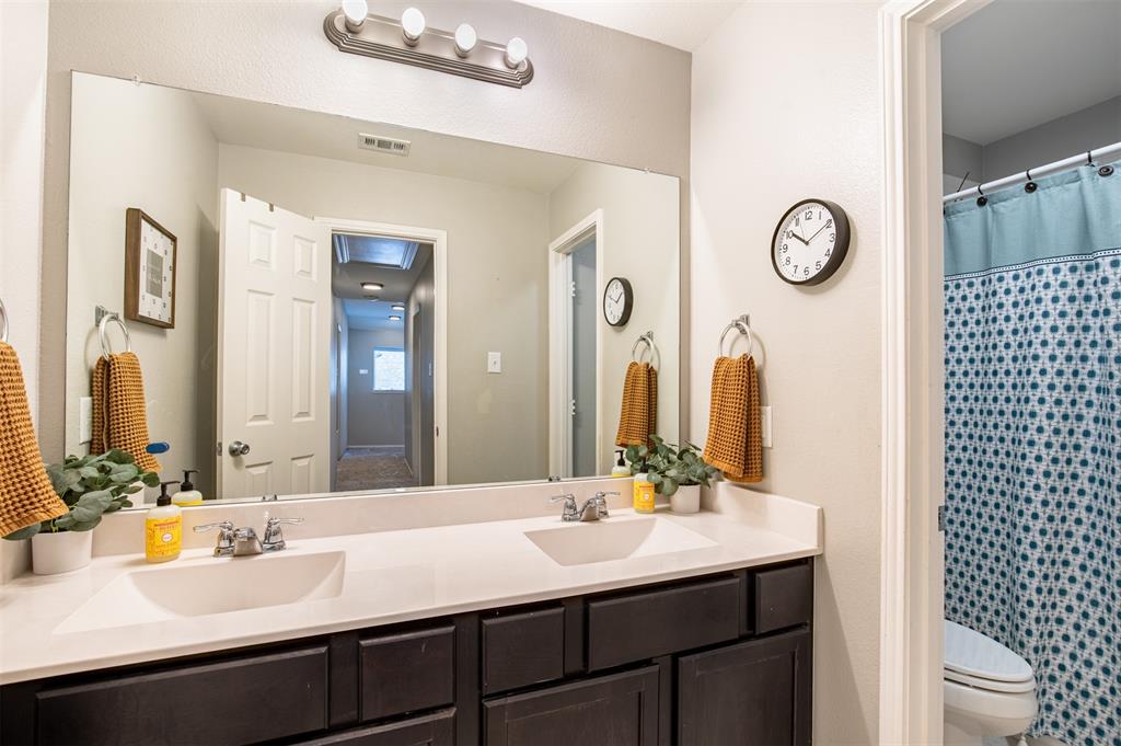416 Allbright Road Celina, TX 75009 - Photo 26 of 40 a bathroom with a double vanity sink and a mirror