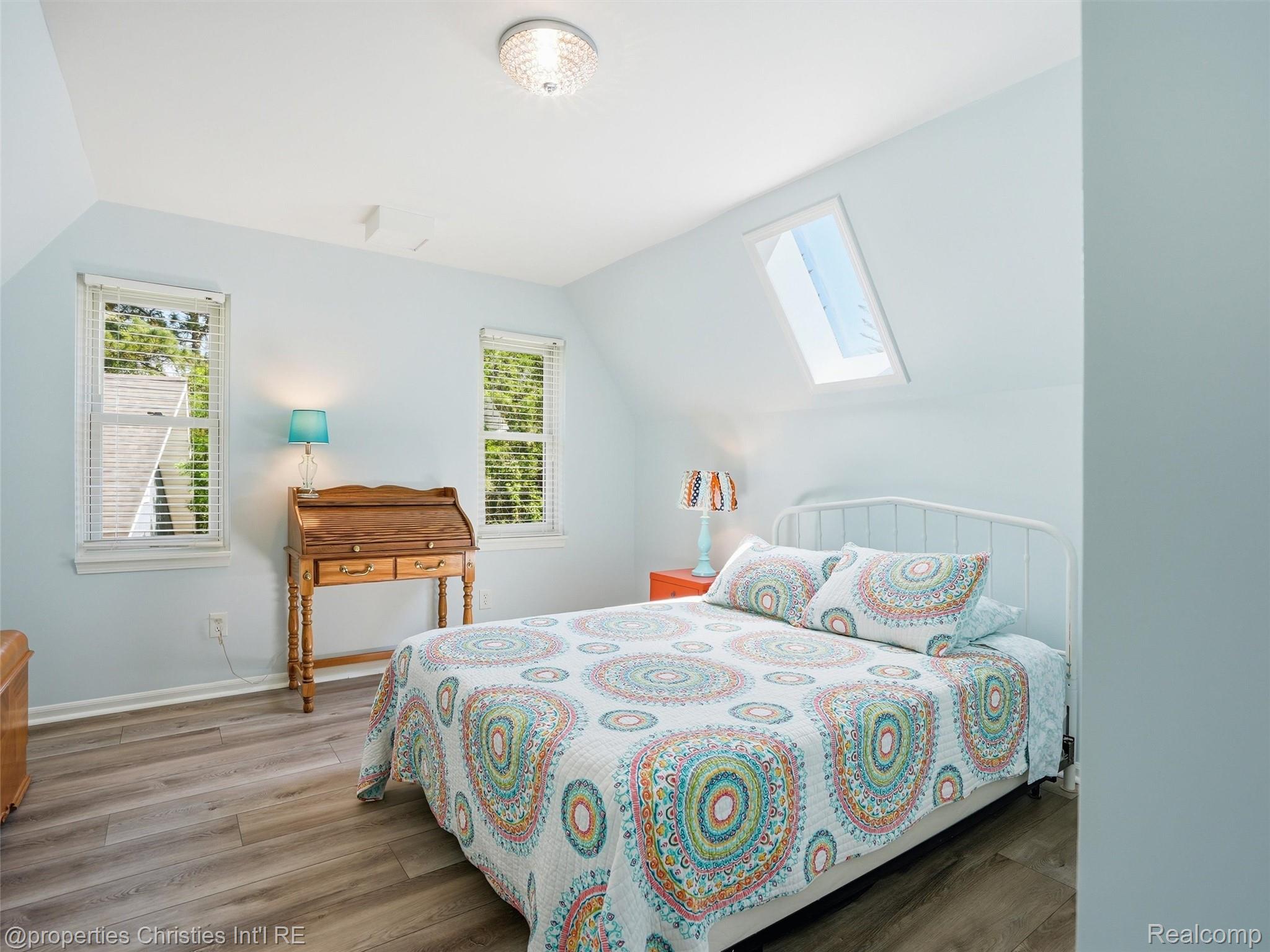 8645 Toma Road Pinckney, MI 48169 - Photo 32 of 65 Light filled bedroom with skylight and laminate flooring