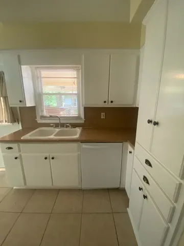 a kitchen with cabinets appliances and a sink