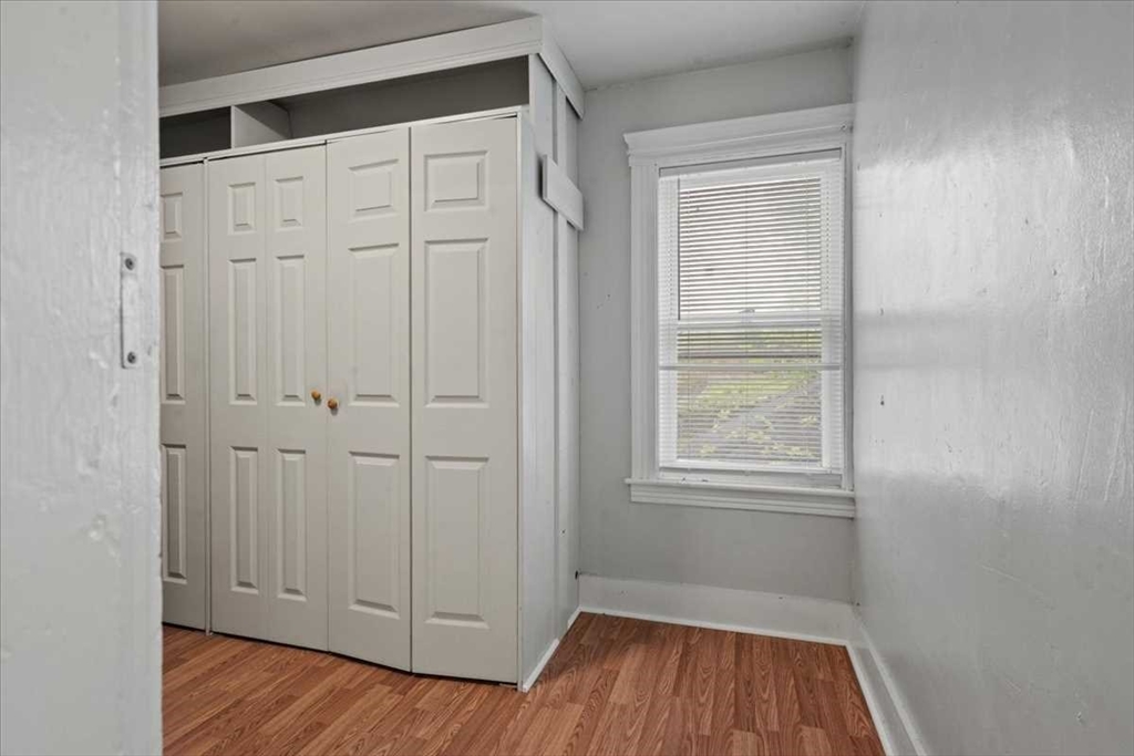 3 Wallace Street Worcester, MA 01605 - Photo 21 of 29 an empty room with wooden floor and windows