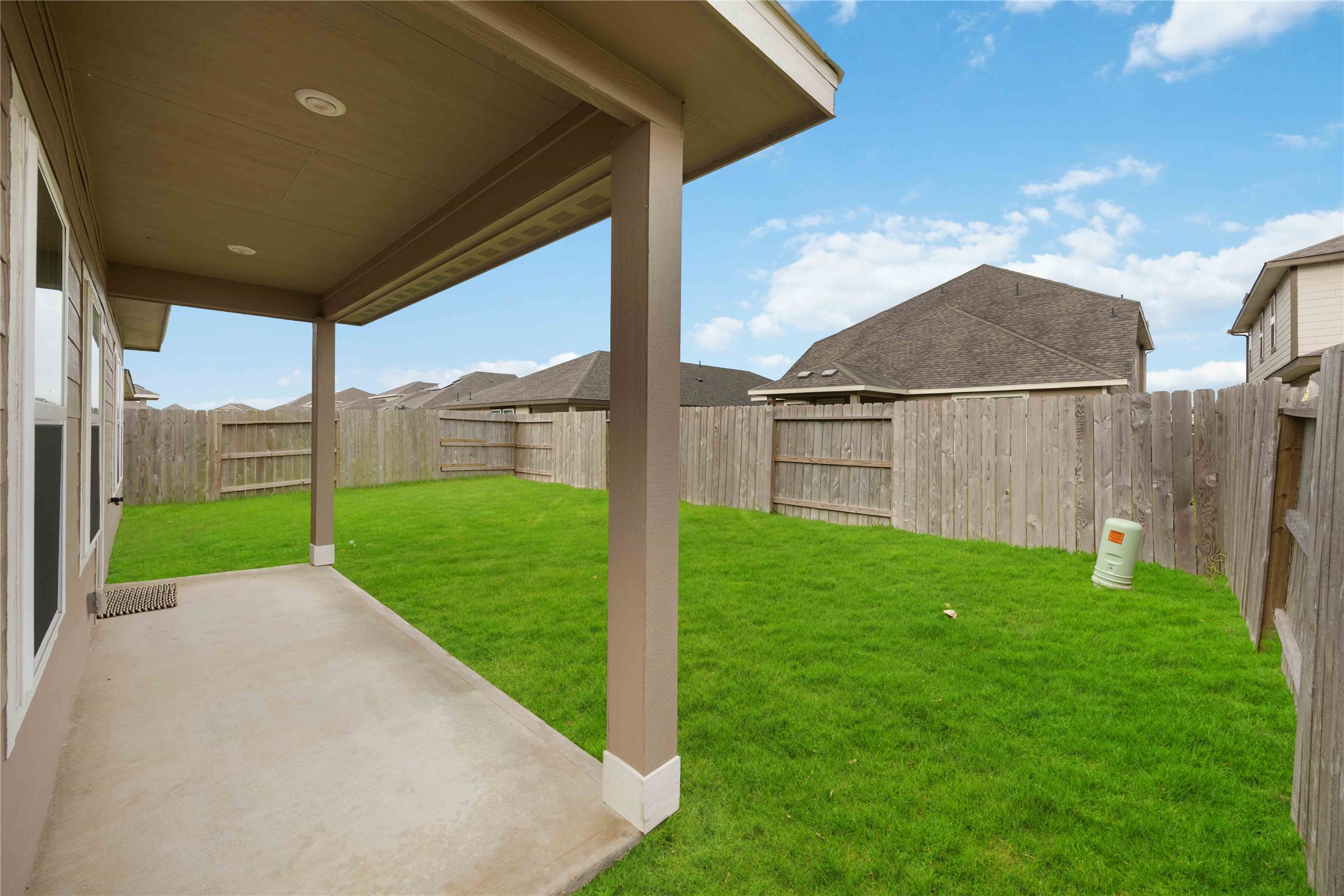 6814 Ventura Drive Rosharon, TX 77583 - Photo 29 of 30 Step onto the covered back porch, just the right size for quiet evenings or weekend lounging—framed by views of the lush lawn.