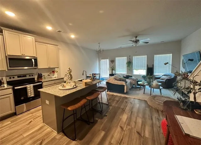 a view of a dining room with furniture a rug and wooden floor