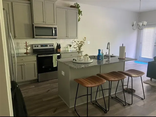 a kitchen with a table chairs stove and cabinets