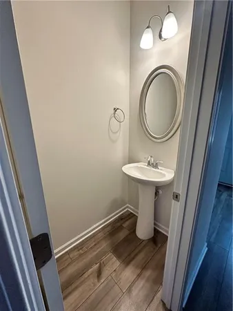a bathroom with a toilet a sink and a mirror