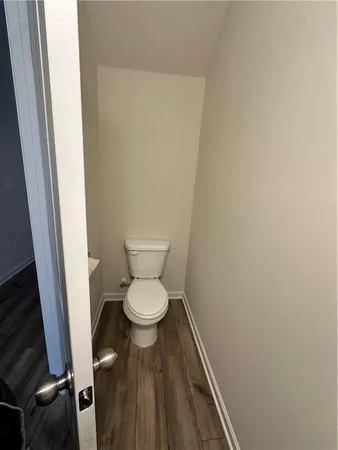 a white toilet sitting next to a small sink
