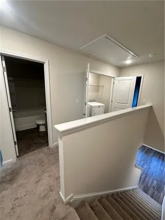 a view of an empty room and kitchen
