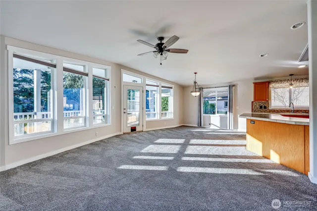 a living room with a fireplace furniture and a large window