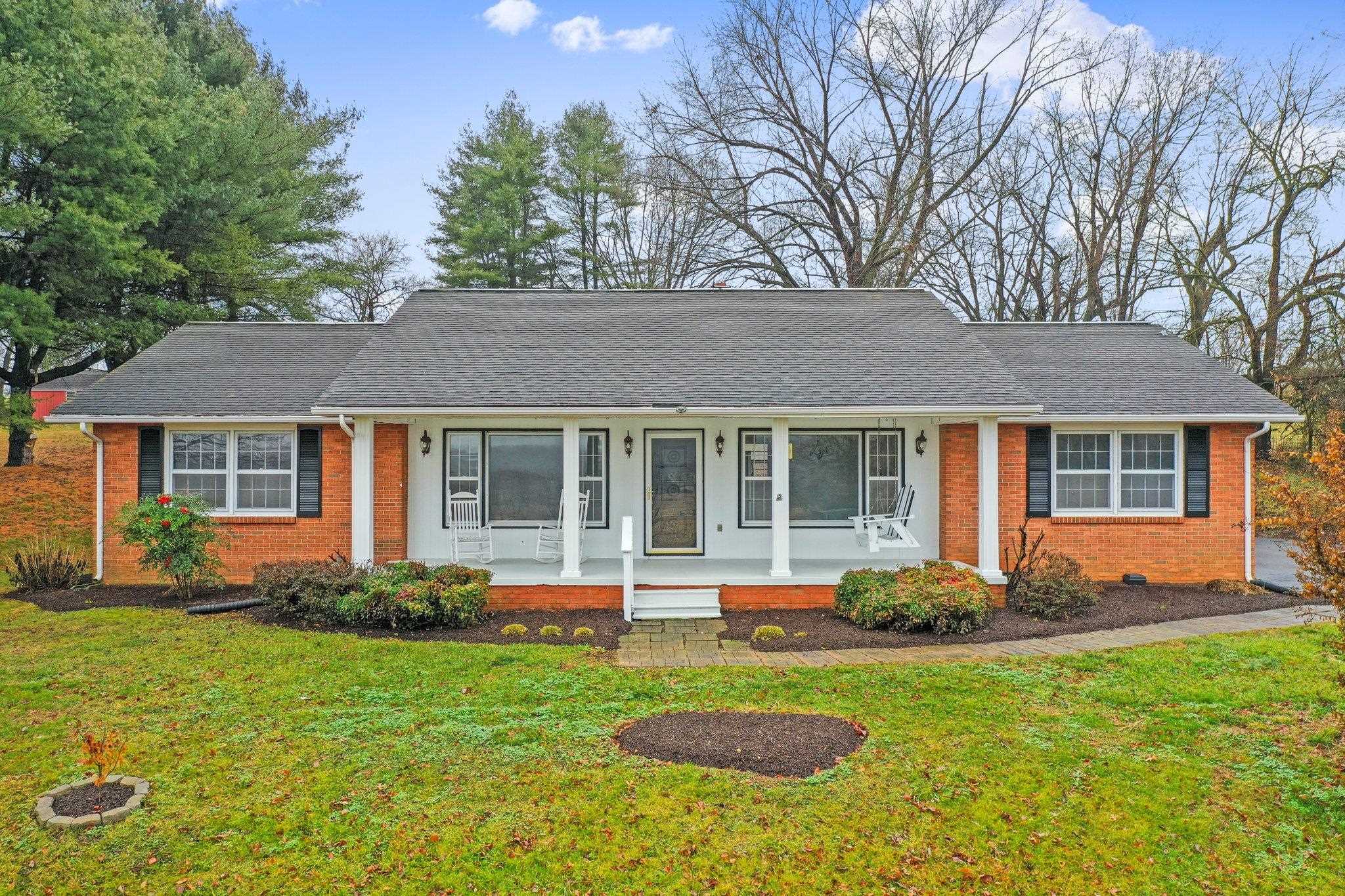 a front view of house with yard and green space