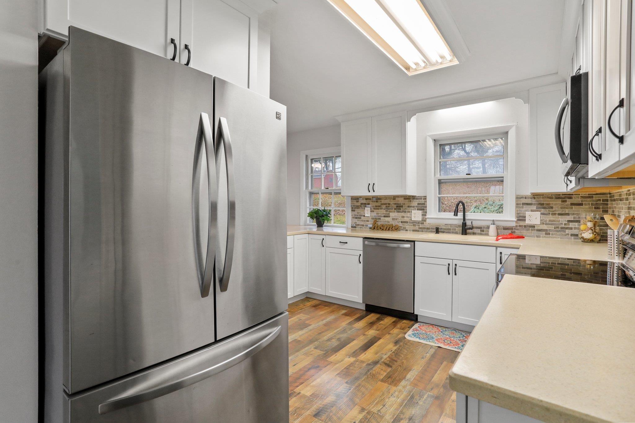 18196 New Market Road Timberville, VA 22853 - Photo 11 of 34 a kitchen with a refrigerator a sink and cabinets