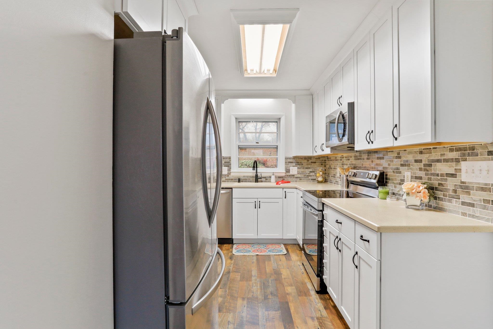 18196 New Market Road Timberville, VA 22853 - Photo 12 of 34 a kitchen with a refrigerator sink and cabinets