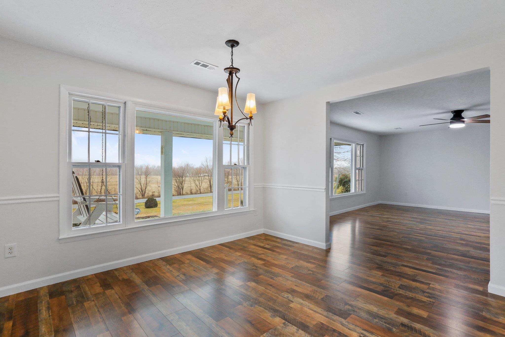 18196 New Market Road Timberville, VA 22853 - Photo 15 of 34 a view of an empty room with wooden floor and a window