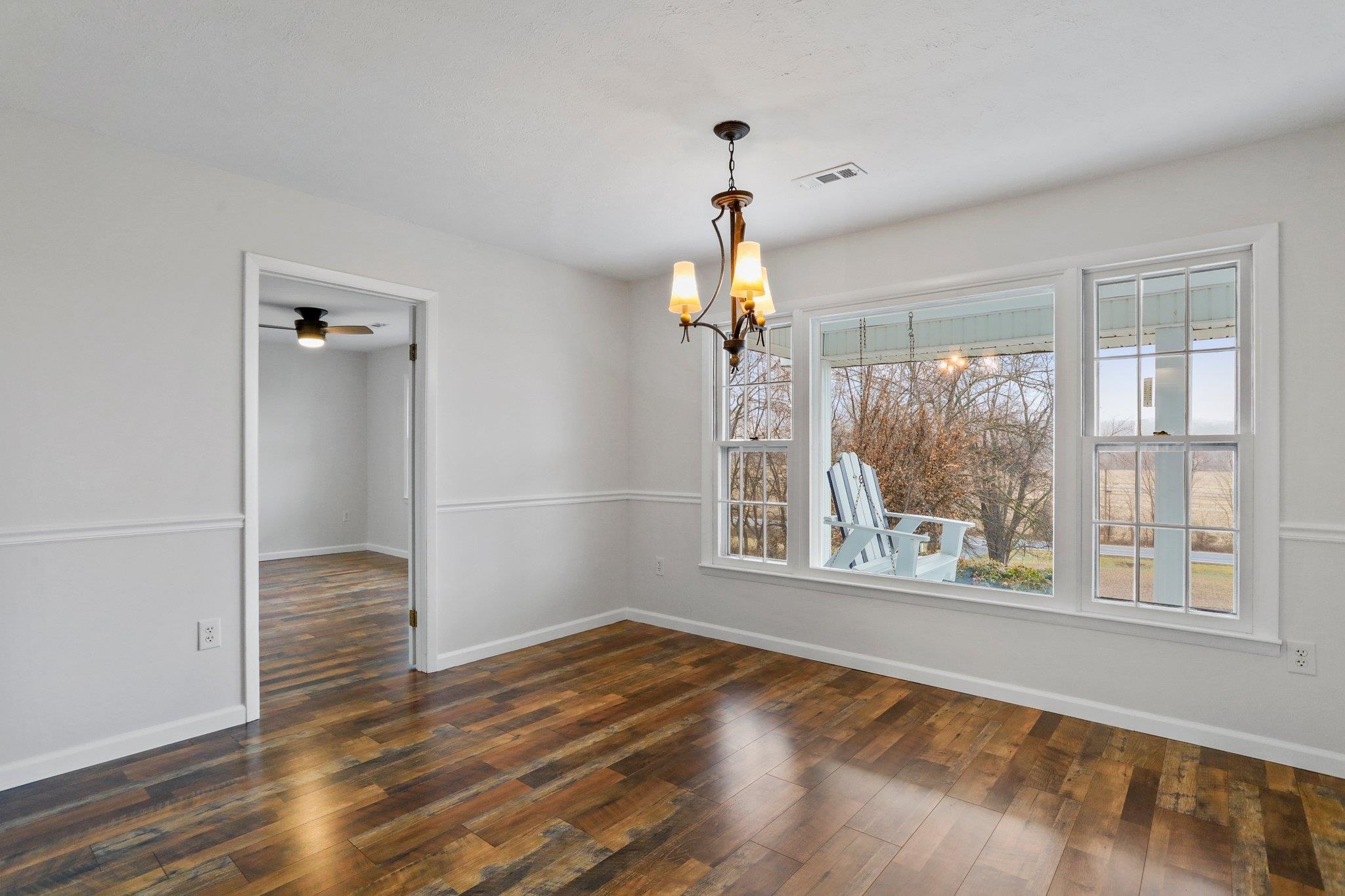 18196 New Market Road Timberville, VA 22853 - Photo 16 of 34 a view of an empty room with wooden floor and a window