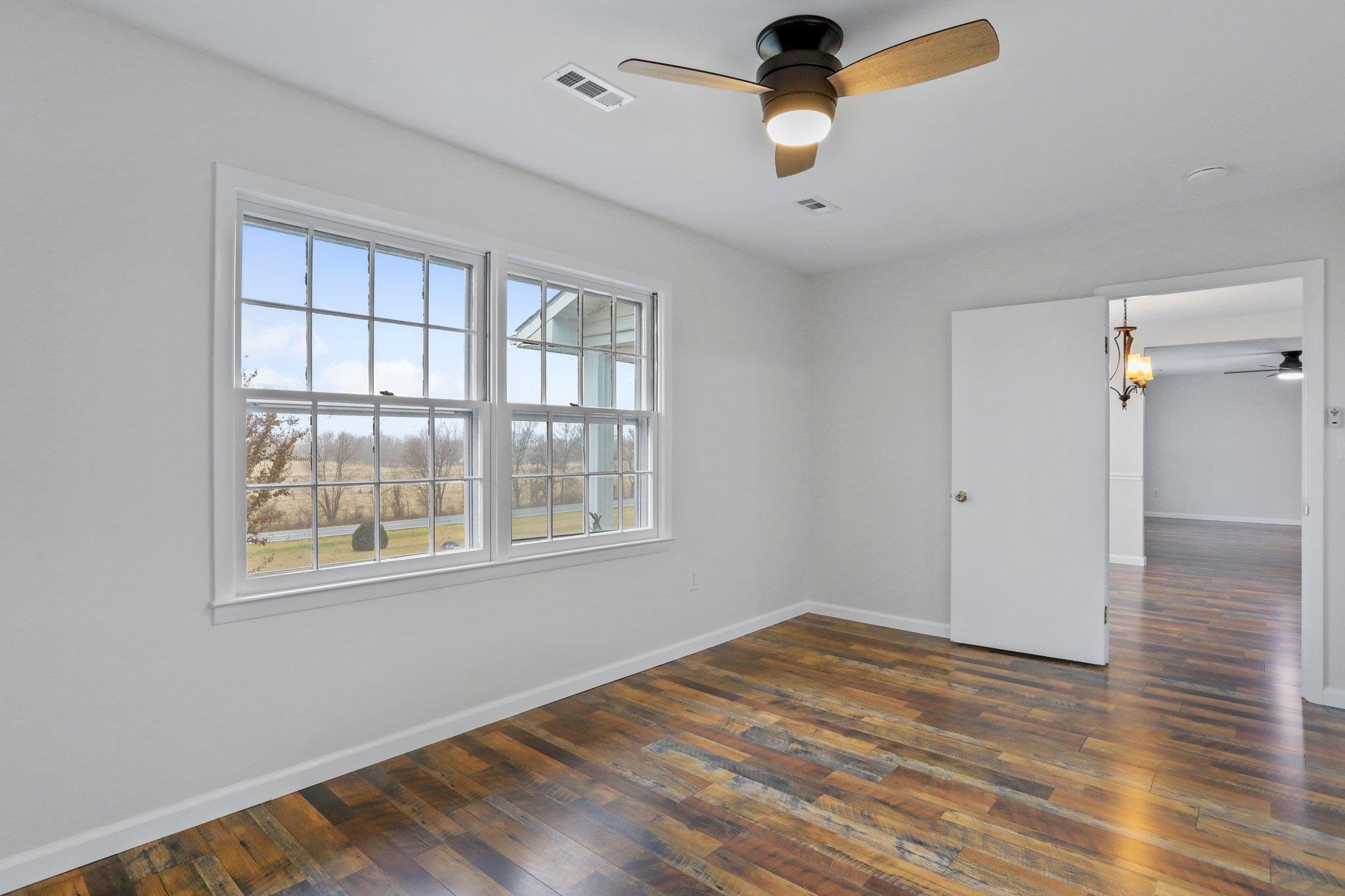 18196 New Market Road Timberville, VA 22853 - Photo 17 of 34 a view of an empty room with wooden floor and a window