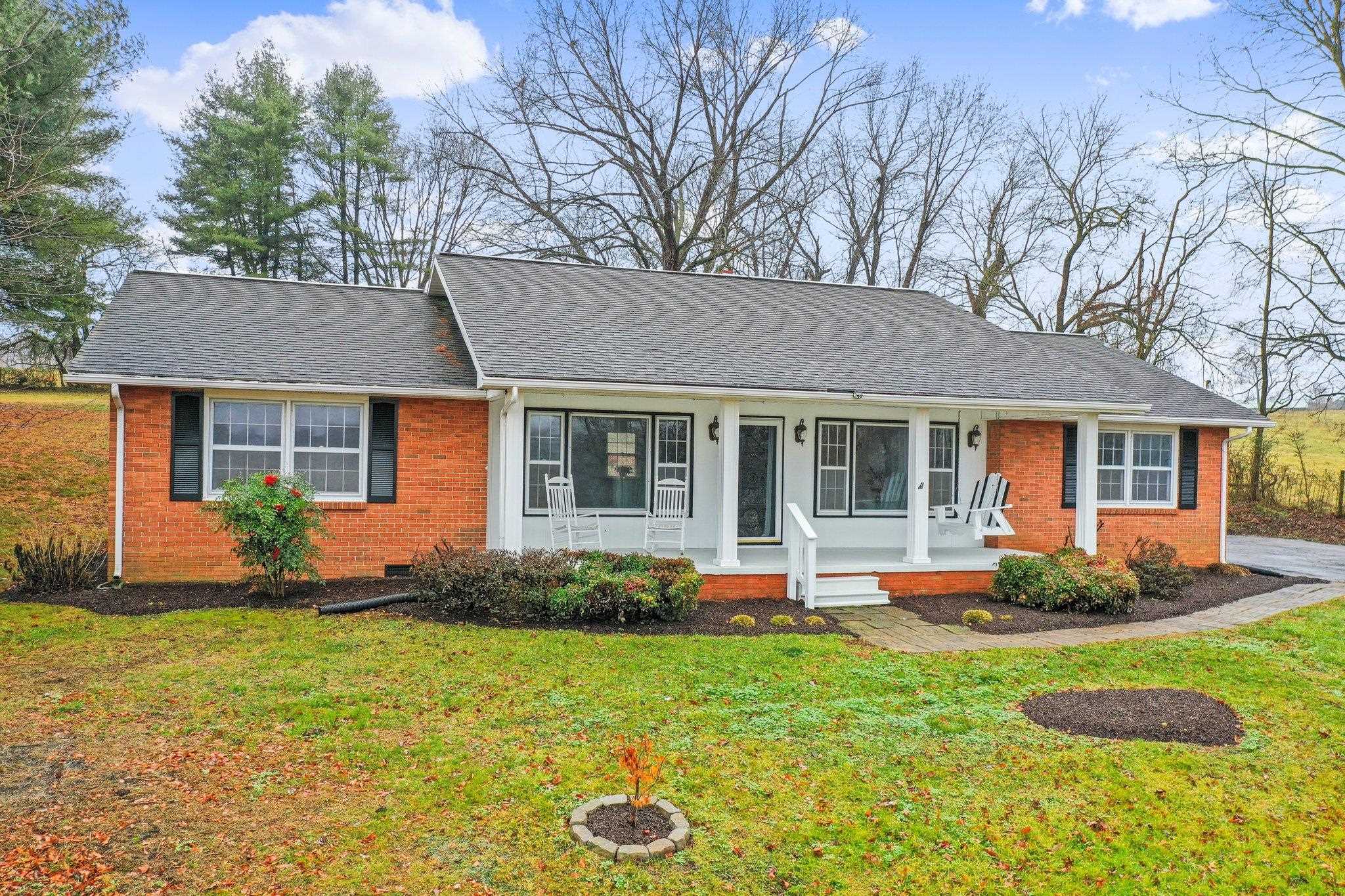 18196 New Market Road Timberville, VA 22853 - Photo 2 of 34 a front view of a house with garden