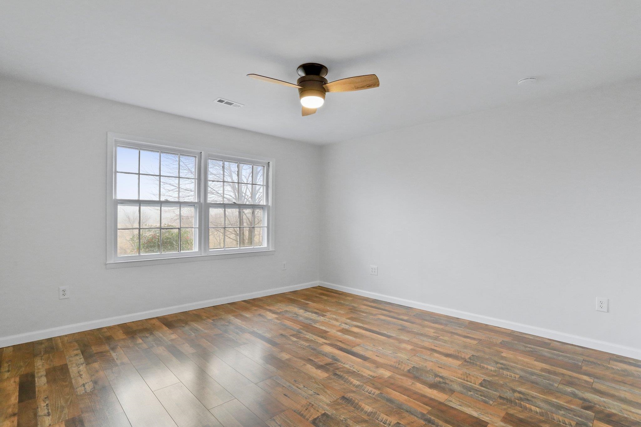 18196 New Market Road Timberville, VA 22853 - Photo 21 of 34 wooden floor in an empty room with a window