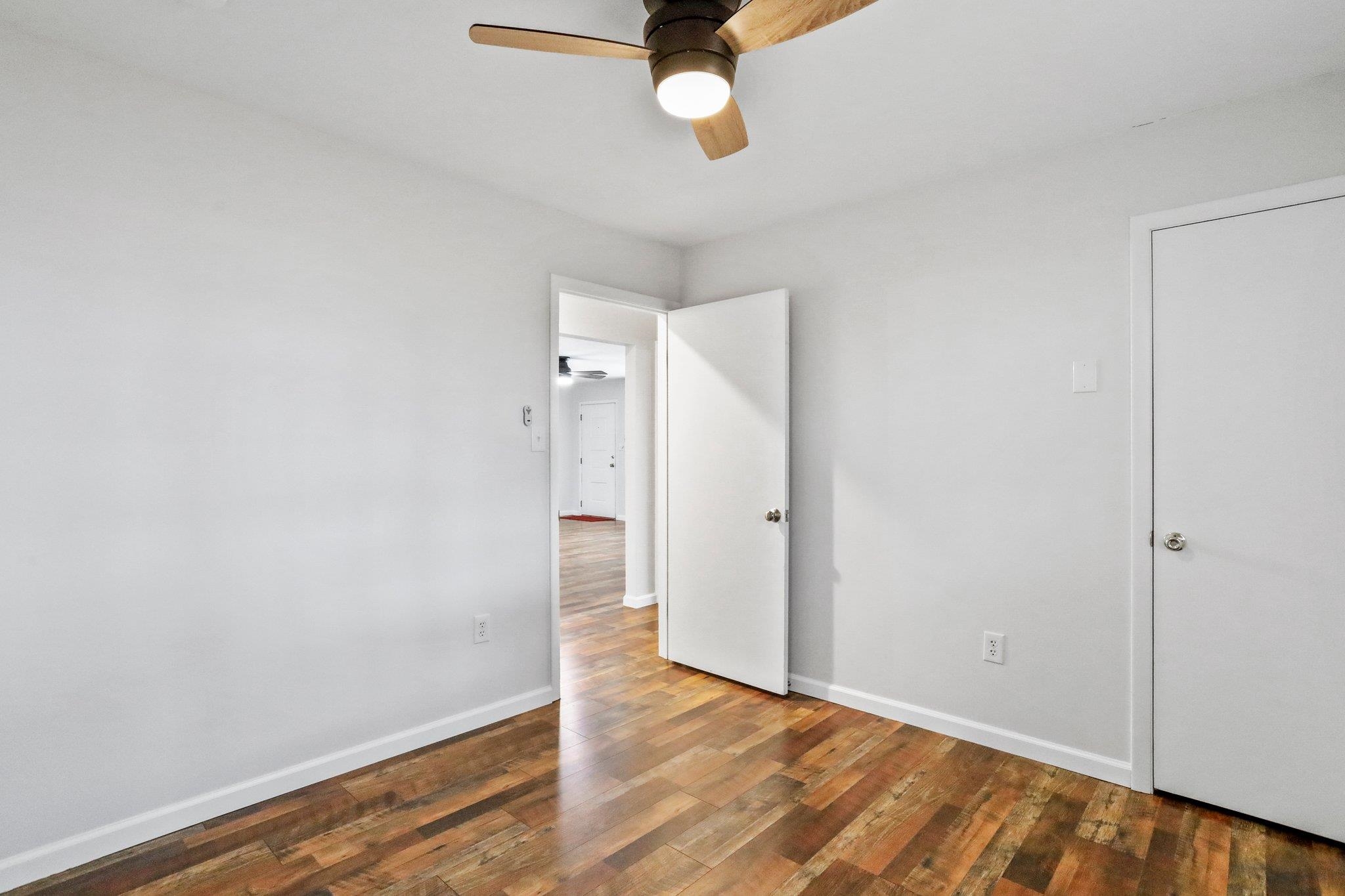 18196 New Market Road Timberville, VA 22853 - Photo 25 of 34 an empty room with wooden floor and windows