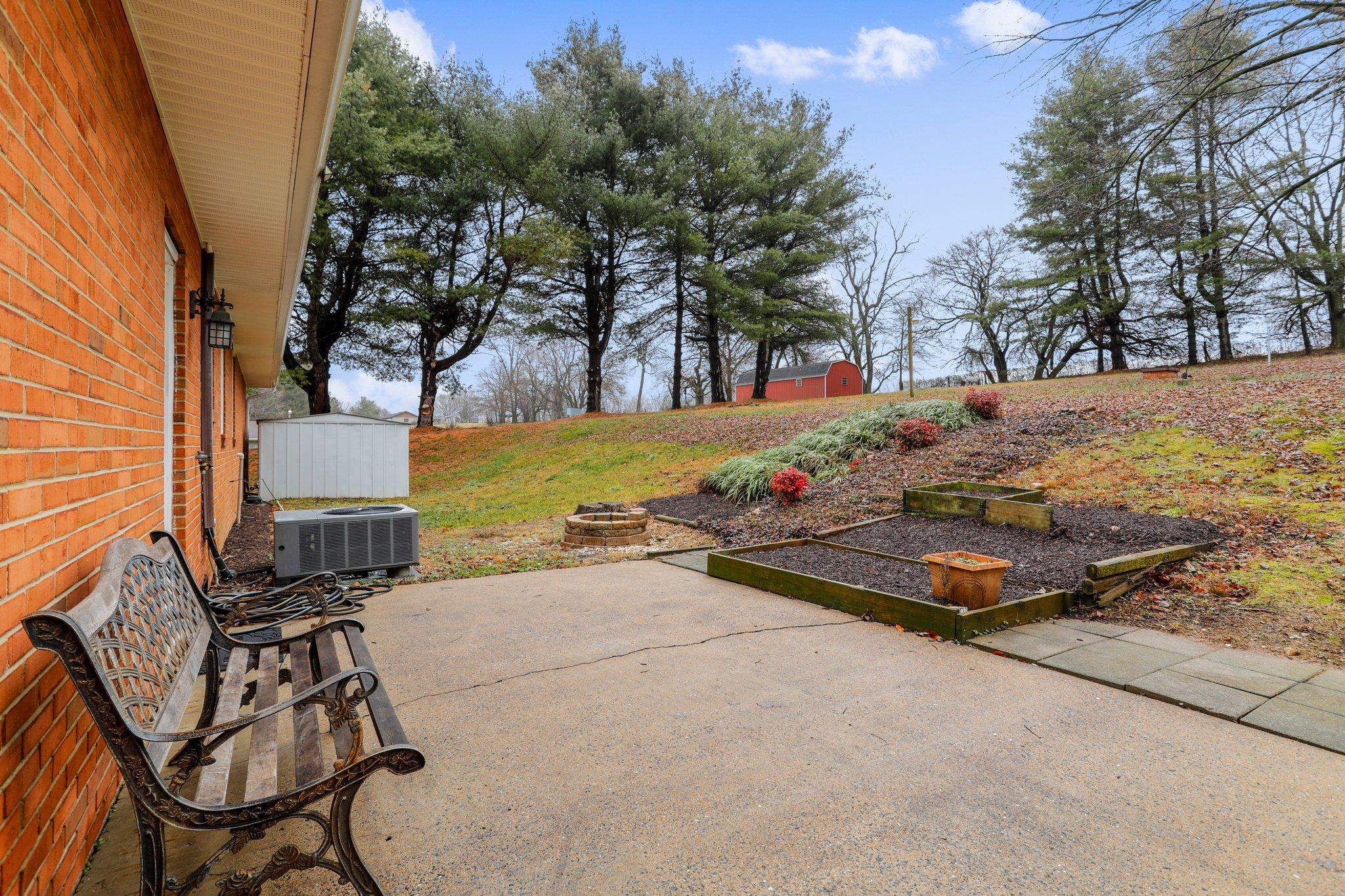 18196 New Market Road Timberville, VA 22853 - Photo 29 of 34 a view of a backyard with chairs and floor to ceiling window